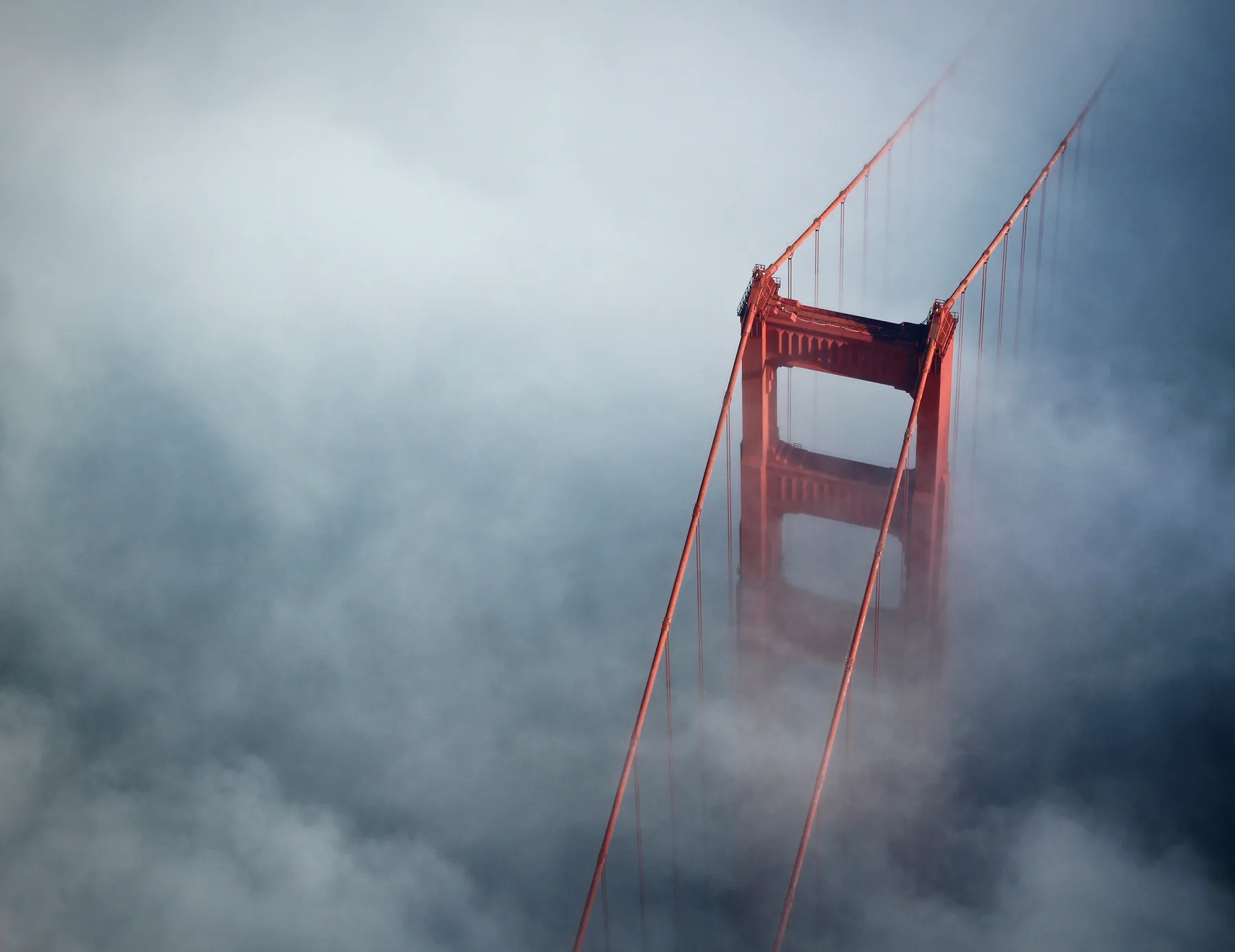 The Golden Gate Bridge emerging through San Francisco fog